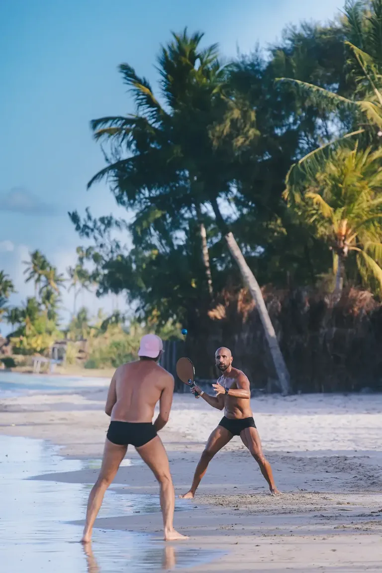 Guests on the sand at Mouton Beach Club